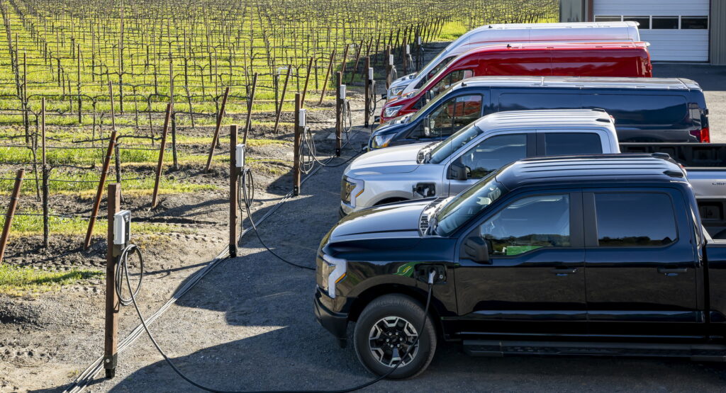 a row of commercial electric vehicles charging